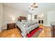 Comfortable main bedroom with hardwood floors, ceiling fan, and a decorative rug adding warmth to the space at 5522 Sharon Rd, Charlotte, NC 28210