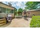 Outdoor patio with grill and dining area surrounded by greenery, providing a serene and private retreat at 5522 Sharon Rd, Charlotte, NC 28210
