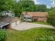 Aerial view of home with a two-car garage and a spacious, well-maintained backyard and patio at 5522 Sharon Rd, Charlotte, NC 28210