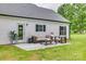 Cozy back patio features outdoor seating and overlooks the backyard with grassy lawn at 5705 White St, Fort Lawn, SC 29714