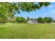 Expansive backyard with lush green grass and mature trees surrounding the property at 5705 White St, Fort Lawn, SC 29714
