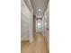 Well-lit hallway with wood-look flooring, closet with wire shelves, and doors leading to various rooms at 5705 White St, Fort Lawn, SC 29714