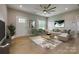 Bright living room with light wood floors, neutral walls, contemporary furnishings, and a stylish ceiling fan at 5705 White St, Fort Lawn, SC 29714