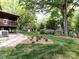 An expansive backyard with a deck and picturesque landscaping creates a serene retreat at 6007 Patrick Pl, Charlotte, NC 28210