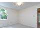 Neutral bedroom featuring a ceiling fan and bright natural light from the window at 6007 Patrick Pl, Charlotte, NC 28210
