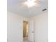 Neutral bedroom featuring a ceiling fan and doorway that leads to a bright bathroom at 6007 Patrick Pl, Charlotte, NC 28210