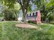 Charming two-story home surrounded by a lush, well-manicured lawn at 6007 Patrick Pl, Charlotte, NC 28210