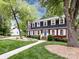 Charming two-story home with manicured landscaping and mature trees at 6007 Patrick Pl, Charlotte, NC 28210