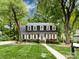 Charming two-story home with mature trees and a manicured lawn at 6007 Patrick Pl, Charlotte, NC 28210
