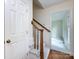 Inviting foyer features a staircase with wood railing and white carpeting at 6007 Patrick Pl, Charlotte, NC 28210