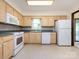 Well-lit kitchen with ample cabinetry and white appliances at 6007 Patrick Pl, Charlotte, NC 28210