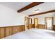 Spacious living room with wood-paneled walls and views to other rooms at 6007 Patrick Pl, Charlotte, NC 28210
