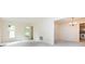 Bright living room with neutral carpet, two windows, and an open doorway to the dining room at 6007 Patrick Pl, Charlotte, NC 28210