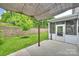 A charming backyard featuring a screened-in porch, patio with canopy, and lush green lawn at 7209 Brookline Pl, Huntersville, NC 28078