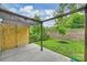 Inviting backyard with a concrete patio covered by a pergola and a privacy wall at 7209 Brookline Pl, Huntersville, NC 28078