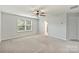 Cozy bedroom with ceiling fan, neutral carpet and window with blind at 7209 Brookline Pl, Huntersville, NC 28078