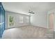 Spacious bedroom with neutral carpet, ceiling fan, and a door to a small balcony at 7209 Brookline Pl, Huntersville, NC 28078