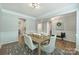 Bright dining area with classic design details and view into other living spaces at 7209 Brookline Pl, Huntersville, NC 28078