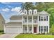 Beautiful two-story traditional home with a welcoming front porch and a two car garage at 7209 Brookline Pl, Huntersville, NC 28078
