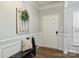 Bright foyer featuring beautiful wainscoting, hardwood floors, and a decorative accent piece at 7209 Brookline Pl, Huntersville, NC 28078