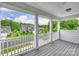 View from the porch of a charming home with a landscaped front yard and a neighborhood street at 7209 Brookline Pl, Huntersville, NC 28078