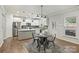 Bright, modern kitchen features stainless steel appliances, a center island, and an adjacent dining area at 7209 Brookline Pl, Huntersville, NC 28078