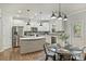Modern kitchen featuring stainless appliances, gray subway tile backsplash, white cabinets and a center island at 7209 Brookline Pl, Huntersville, NC 28078