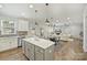 Spacious kitchen flows into the living room with a fireplace, creating an inviting open-concept living space at 7209 Brookline Pl, Huntersville, NC 28078