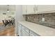Convenient bar area connects kitchen and dining room with quartz counters and gray subway tile backsplash at 7209 Brookline Pl, Huntersville, NC 28078