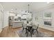 Bright, modern kitchen features stainless steel appliances, a center island, and an adjacent dining area at 7209 Brookline Pl, Huntersville, NC 28078