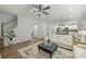 Spacious living area with hardwood floors, ceiling fan, and view into the kitchen at 7209 Brookline Pl, Huntersville, NC 28078