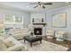 Comfortable living room featuring a fireplace, neutral tones, and a ceiling fan at 7209 Brookline Pl, Huntersville, NC 28078