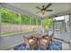 Screened porch with a wooden table and chairs, a ceiling fan, and an outdoor view at 7209 Brookline Pl, Huntersville, NC 28078