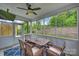 Screened porch featuring a wooden table and chairs with views of the backyard and green landscape at 7209 Brookline Pl, Huntersville, NC 28078