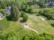 Aerial view showcasing the golf course with lush green fairways and manicured greens surrounded by beautiful homes at 7280 Woodside Ct, Denver, NC 28037