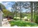 Serene backyard with lush landscaping and a view of the golf course, offering a peaceful retreat at 7280 Woodside Ct, Denver, NC 28037