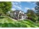 Spacious backyard featuring multiple outdoor living spaces and lush landscaping at 7280 Woodside Ct, Denver, NC 28037