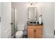 Cozy bathroom featuring a single vanity and glass shower with updated fixtures and warm lighting at 7280 Woodside Ct, Denver, NC 28037