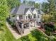 Stunning exterior elevation featuring a spacious deck, covered patio, and beautifully landscaped backyard, ideal for outdoor living at 7280 Woodside Ct, Denver, NC 28037