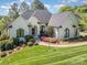 Charming white brick home featuring a manicured lawn and beautifully landscaped front yard at 7280 Woodside Ct, Denver, NC 28037