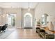Bright foyer boasting light wood floors, a statement mirror, console table, and modern light fixture at 7280 Woodside Ct, Denver, NC 28037