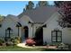 Charming single-story home featuring a beautifully landscaped yard, arched doorway and black trimmed windows at 7280 Woodside Ct, Denver, NC 28037