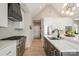 Modern kitchen with stainless steel appliances, white marble countertops, and a black range hood at 7280 Woodside Ct, Denver, NC 28037