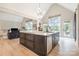 Modern kitchen with a large center island, ample storage, stainless steel appliances, and access to the patio at 7280 Woodside Ct, Denver, NC 28037