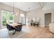 Open-concept living area featuring high ceilings, modern lighting, light wood floors, and lots of natural light at 7280 Woodside Ct, Denver, NC 28037