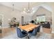 Bright living space featuring a vaulted ceiling, lots of windows, comfortable seating, and light wood floors at 7280 Woodside Ct, Denver, NC 28037