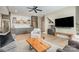 Open-concept living room with hardwood floors, a large TV, beverage bar and cozy seating at 7280 Woodside Ct, Denver, NC 28037