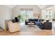 Cozy living room featuring vaulted ceiling, large windows, comfortable furniture, and light wood floors at 7280 Woodside Ct, Denver, NC 28037