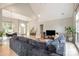 Open floor plan showcasing the living room, dining area, and foyer, featuring natural light and wood floors at 7280 Woodside Ct, Denver, NC 28037