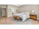 Bright main bedroom featuring hardwood floors, a tray ceiling, and a sitting area rug at 7280 Woodside Ct, Denver, NC 28037